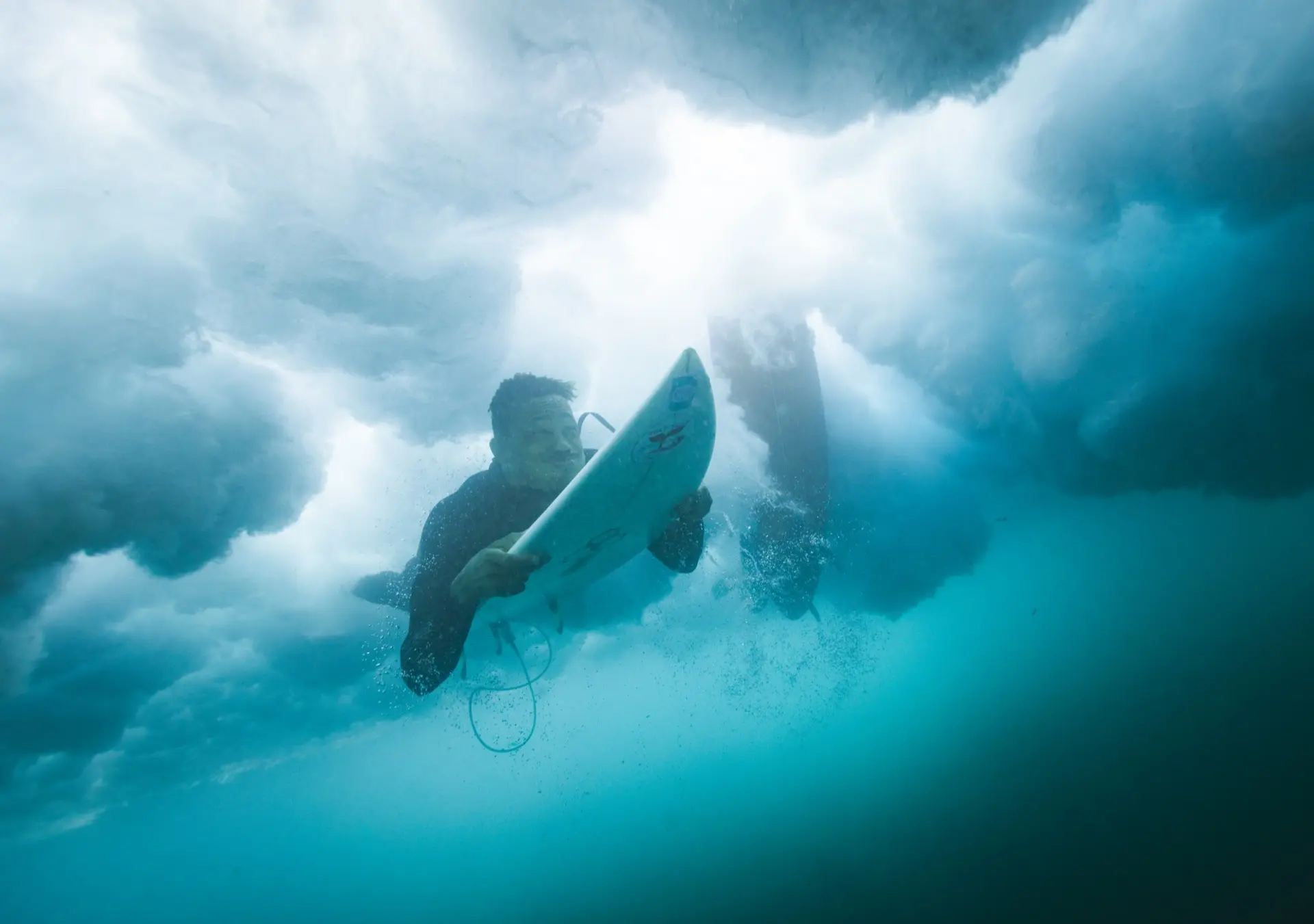Underwater surfers with light rays