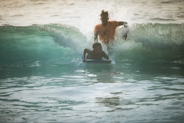 Pushing student in waves